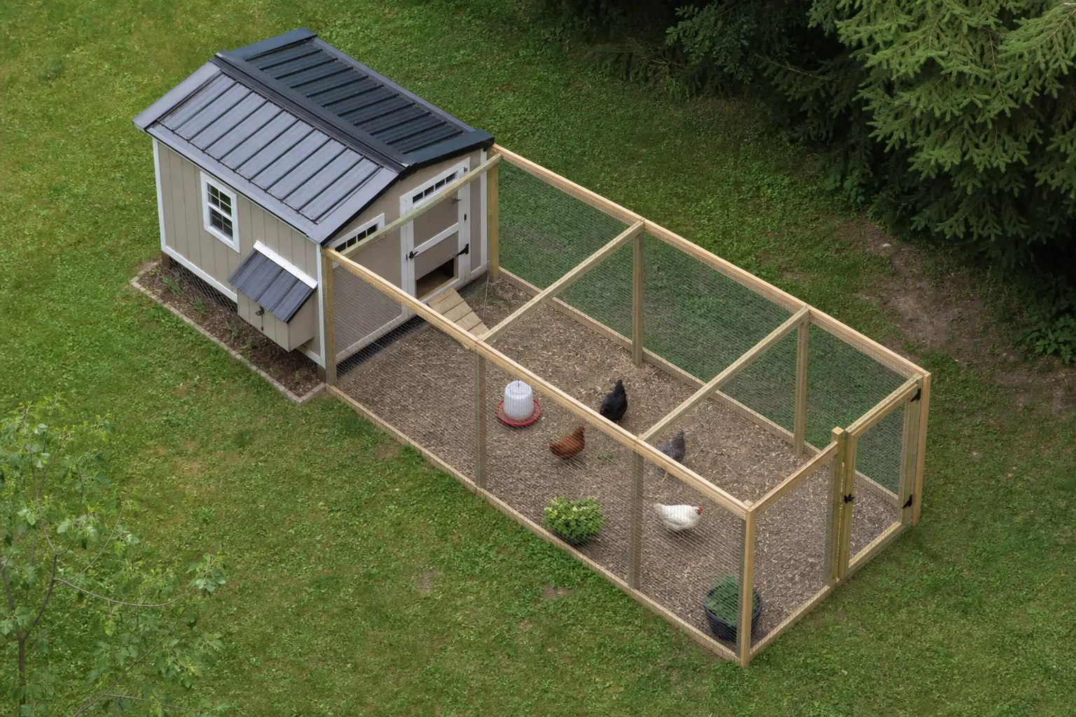 Overhead view of a backyard layout showing a coop, run, and fenced yard space